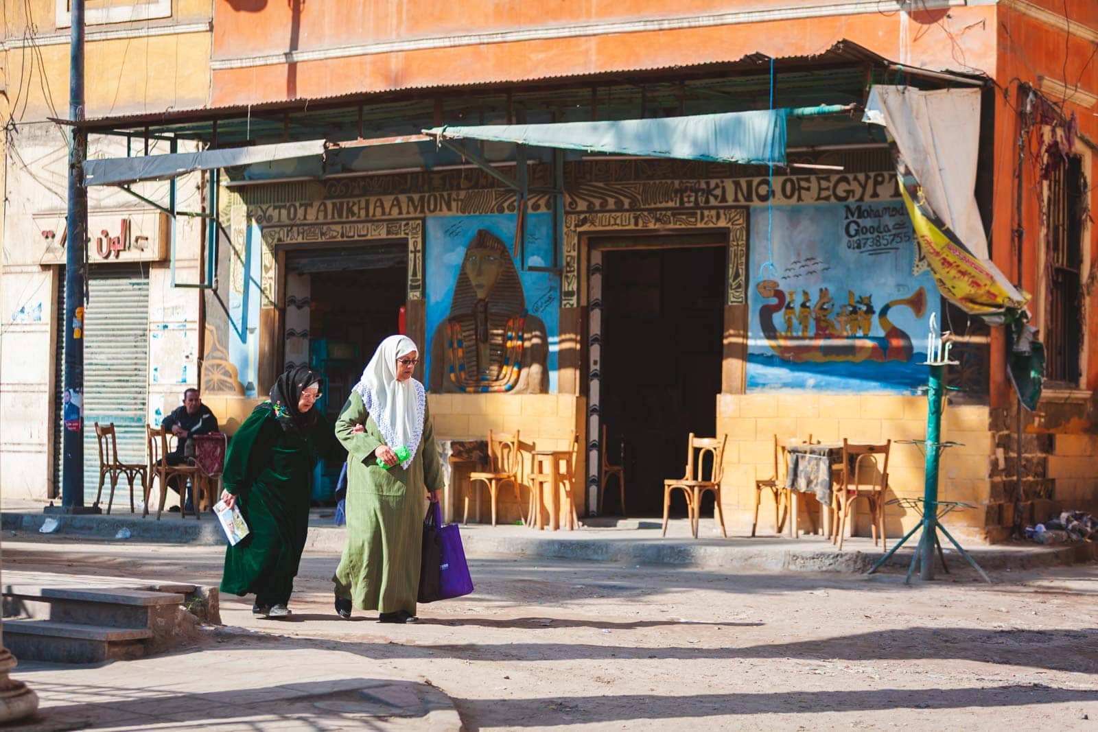 A bustling street in  Cairo with pedestrians, showing daily life and contrasting with outdated news reports.